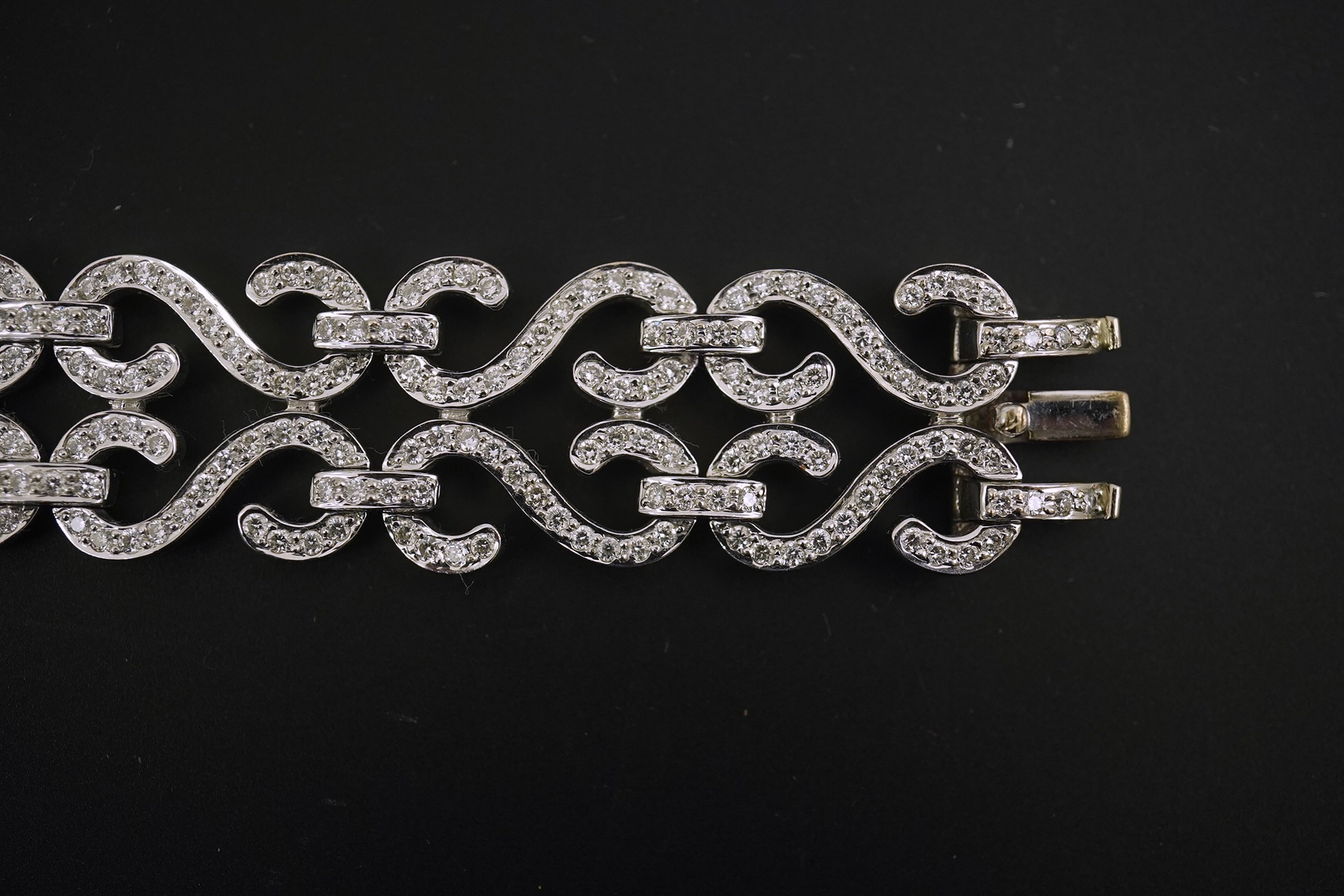 A modern 18k white gold and diamond chip cluster set bracelet